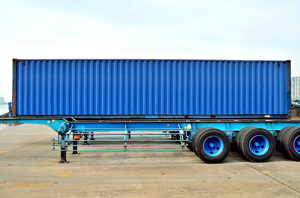 Cargo container and semi trailer chassis